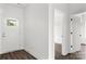 Clean entryway with a white door and LVP flooring, leading to other rooms in the home at 143 Tranquility Ln, Harmony, NC 28634