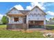New construction home featuring a brick foundation and a two-car garage, ready to be completed at 143 Tranquility Ln, Harmony, NC 28634