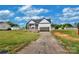 New home with white and gray siding with a two-car garage and long driveway at 143 Tranquility Ln, Harmony, NC 28634
