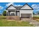 New construction showing a two-story home with an attached garage still in progress at 143 Tranquility Ln, Harmony, NC 28634