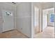 Unfinished hallway leading to a door with window, and two open doorways at 143 Tranquility Ln, Harmony, NC 28634