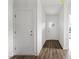 Bright hallway with hardwood floors and white doors at 143 Tranquility Ln, Harmony, NC 28634