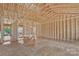 Unfinished interior framing of a new home, showcasing the spacious open floor plan and high ceilings at 143 Tranquility Ln, Harmony, NC 28634