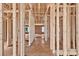 The wood framework defines the open floorplan, revealing spacious rooms and window placements at 143 Tranquility Ln, Harmony, NC 28634