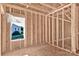A room shows the window placement, wooden framework and subfloor ready for finishing and design at 143 Tranquility Ln, Harmony, NC 28634