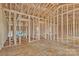 The interior framing outlines the rooms, featuring an open concept and multiple windows for future natural light at 143 Tranquility Ln, Harmony, NC 28634