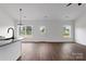 Bright living room featuring hardwood floors, fresh paint, and natural light from double windows at 143 Tranquility Ln, Harmony, NC 28634