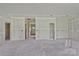 A spacious open-concept living room with unfinished drywall ready for customization and personal design at 143 Tranquility Ln, Harmony, NC 28634