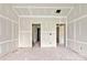 An open-concept living room displaying multiple doorways and drywall ready for paint and trim at 143 Tranquility Ln, Harmony, NC 28634