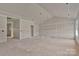 A spacious open-concept living room with unfinished drywall ready for customization and personal design at 143 Tranquility Ln, Harmony, NC 28634