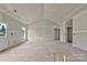 A bright and airy living room featuring a large window and a door to the backyard, ready for your design at 143 Tranquility Ln, Harmony, NC 28634
