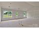 A bright and airy living room featuring a large window and a door to the backyard, ready for your design at 143 Tranquility Ln, Harmony, NC 28634