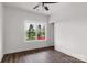 Bright bedroom featuring wood-look floors, white walls, a window, and ample doorway access at 149 Tranquility Ln, Harmony, NC 28634