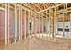 Spacious bedroom featuring wall and ceiling frame, pink insulation, and view to the bathroom at 149 Tranquility Ln, Harmony, NC 28634