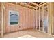 A bedroom featuring wall and ceiling frame, pink insulation, and a window overlooking the exterior at 149 Tranquility Ln, Harmony, NC 28634