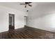 Spacious bedroom features wood-look flooring, white walls, and ample doorway access at 149 Tranquility Ln, Harmony, NC 28634