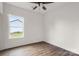Bright bedroom with wood-look floors, white walls, and a window overlooking the backyard at 149 Tranquility Ln, Harmony, NC 28634