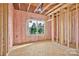 Framed bedroom featuring insulation, natural light from the window, and plywood subflooring at 149 Tranquility Ln, Harmony, NC 28634