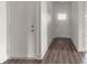 Bright entryway featuring wood-look flooring, white walls, and a glass paneled front door at 149 Tranquility Ln, Harmony, NC 28634