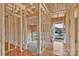 Unfinished entryway with wood framing, concrete slab, and gravel, providing the base for a welcoming entrance at 149 Tranquility Ln, Harmony, NC 28634