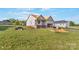 Exterior view of a new home build with large yard and partial brick facade at 149 Tranquility Ln, Harmony, NC 28634