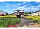Charming two-story home with a dark blue exterior, black roof, and a long driveway at 149 Tranquility Ln, Harmony, NC 28634