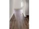 Hallway features wood-look flooring, white trim, and a view of bright airy room at 149 Tranquility Ln, Harmony, NC 28634