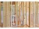 Unfinished interior showing wooden frame construction with insulation and exposed plywood subflooring at 149 Tranquility Ln, Harmony, NC 28634