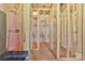 Unfinished interior showing wooden frame construction with insulation and exposed plywood subflooring at 149 Tranquility Ln, Harmony, NC 28634