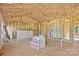 Unfinished interior showing wooden frame construction with insulation and exposed plywood subflooring at 149 Tranquility Ln, Harmony, NC 28634