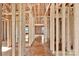 An unfinished interior view of new construction showcasing open wood framing and the future layout at 149 Tranquility Ln, Harmony, NC 28634