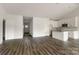This open-concept kitchen is complete with white cabinets, granite countertops, and wood-look floors at 149 Tranquility Ln, Harmony, NC 28634