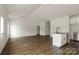 Open-concept kitchen featuring granite countertops, white cabinets, and modern appliances at 149 Tranquility Ln, Harmony, NC 28634