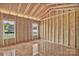 Framed room in a new build home featuring exposed walls and window openings at 149 Tranquility Ln, Harmony, NC 28634
