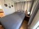 Bedroom with gray bedding and wood-paneled walls at 168 Clubhouse Dr, New London, NC 28127
