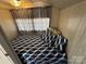 Small bedroom with blue and white bedding and gingham curtains at 168 Clubhouse Dr, New London, NC 28127