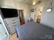 Bedroom with a TV, dresser, and view into another room at 168 Clubhouse Dr, New London, NC 28127