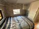 Small bedroom with stone-patterned walls and a double bed at 168 Clubhouse Dr, New London, NC 28127