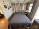 Bright bedroom with gray bedding and wood-paneled walls at 168 Clubhouse Dr, New London, NC 28127