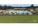 Large community pool with plenty of umbrellas and seating at 168 Clubhouse Dr, New London, NC 28127