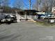 Small cottage with a deck and ramp, nestled in a lakeside community at 168 Clubhouse Dr, New London, NC 28127