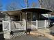 Lakefront property featuring a cozy cottage with a deck and covered porch at 168 Clubhouse Dr, New London, NC 28127