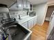 Small kitchen with white cabinets, updated countertops, and stainless steel sink at 168 Clubhouse Dr, New London, NC 28127