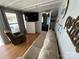Relaxing living room featuring a sofa, armchair, and large TV at 168 Clubhouse Dr, New London, NC 28127