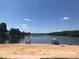 Sandy beach with lake access and picnic umbrellas at 168 Clubhouse Dr, New London, NC 28127