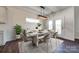 Bright dining room features a marble table, modern light fixture, and access to backyard at 18011 Wilbanks Rd, Charlotte, NC 28278