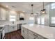 Stylish kitchen with white cabinets, a quartz island countertop, stainless steel appliances, and pendant lights at 18011 Wilbanks Rd, Charlotte, NC 28278