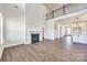 Light-filled living room features a gas fireplace and high ceilings at 18011 Wilbanks Rd, Charlotte, NC 28278