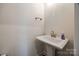 Clean powder room with pedestal sink and modern fixtures at 18011 Wilbanks Rd, Charlotte, NC 28278