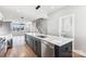 Modern kitchen with island, stainless steel appliances, and white cabinets at 1927 W Trade St, Charlotte, NC 28216